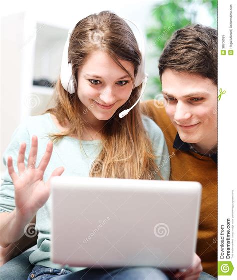 Happy Young Couple Talking Through The Computer With Video Chat Stock