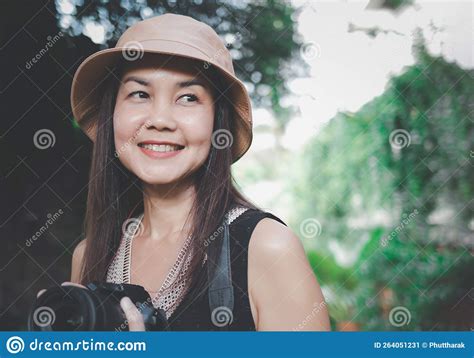 Asian Woman Wearing Hat And Black Top Sleeveless Standing In The