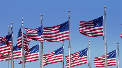A Slow Motion Shot Of American Flags Blowing In The Wind At The
