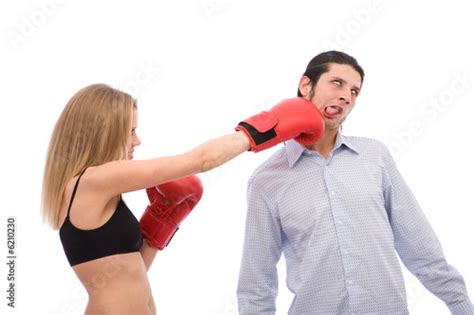 Young Girl Punching A Man On White Background Stock Photo And Royalty