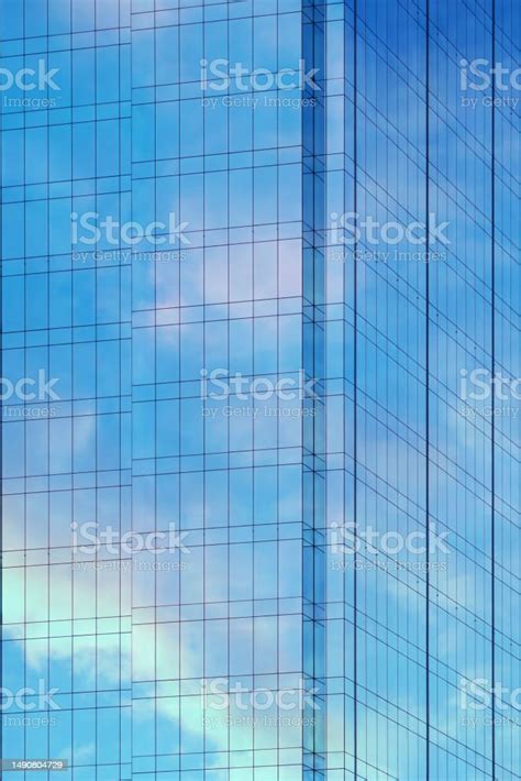 Reflection Of Sky And Clouds In Glass Wall Of Highrise Building Glass