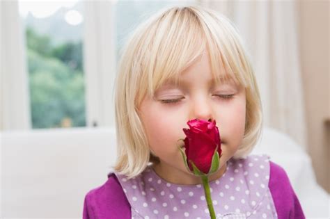 Premium Photo Cute Little Girl Holding A Red Rose