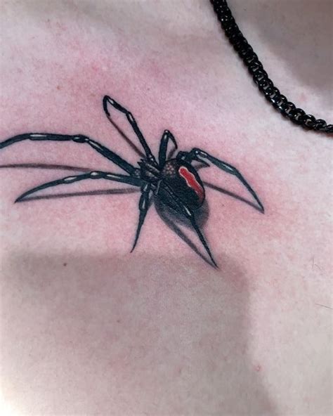 A Black And Red Spider Tattoo On The Chest