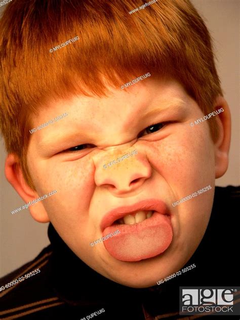 Young Boy Makes Funny Face Against Glass Distorting His Facial