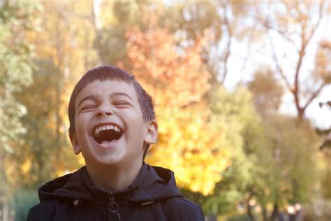 Emotion Of Joy Beautiful Smile Of A Child In The Autumn Park On The