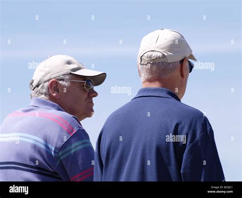 Two Old Men Wearing Baseball Caps Taken From Behind Stock Photo Alamy