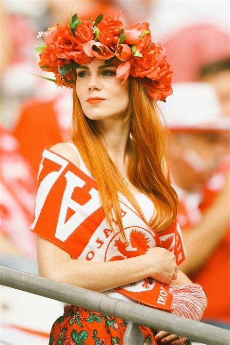 A Woman With Long Red Hair And Flowers In Her Hair Is Wearing A Flower Crown