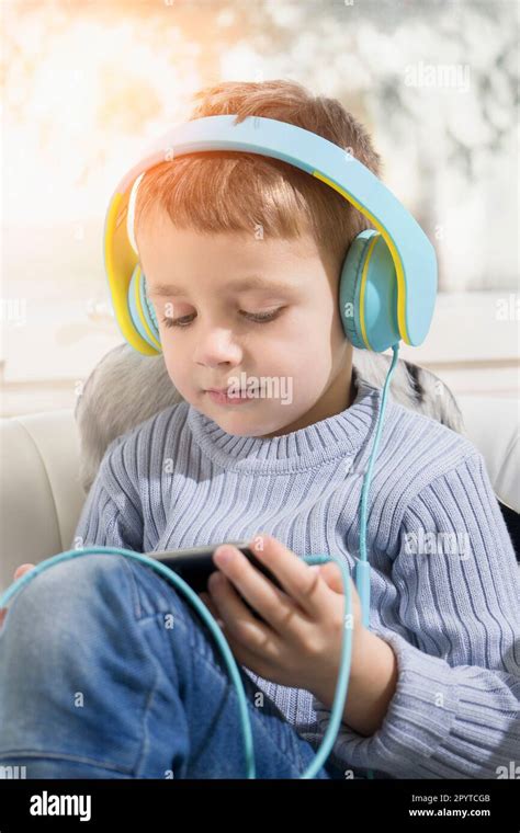 Boy Listening Music Using Digital Tablet And Headphones Stock Photo Alamy