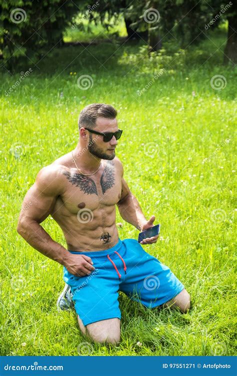 Handsome Muscular Shirtless Hunk Man Outdoor In City Park Stock Image