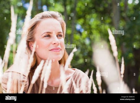 Woman Sitting In Tall Grass Stock Photo Alamy