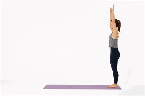 A Woman Doing Yoga Poses With Her Hands Up In The Air On A Purple Mat