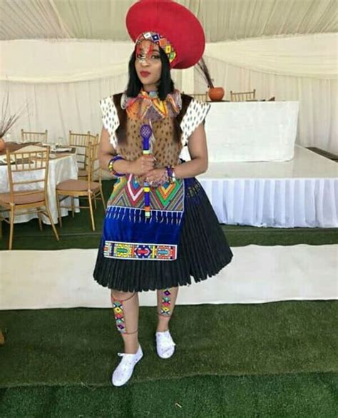 zulu bride in traditional imvunulo wedding attire with red isicholo hat clipkulture clipkulture