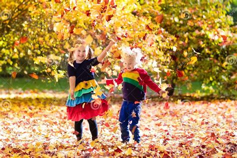 Kids Play In Autumn Park Children In Fall Stock Photo Image Of Fall