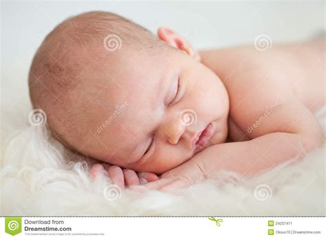 However, parents believe that it's a dangerous posture. Newborn Baby Girl Sleeping On Her Stomach Stock Image ...