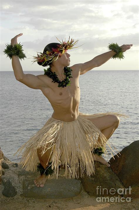 Male Hula Dancer Poses On The Beach In A Traditional Sun Worship Move