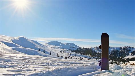 Snowboard Stand In Snow With Beautiful White Caucasus Mountains