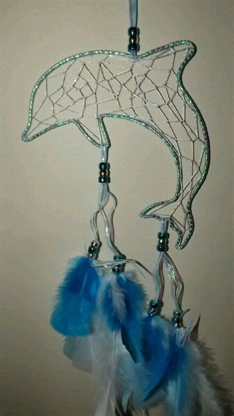 A Blue And White Dream Catcher Hanging From A Hook On A Wall In A Room