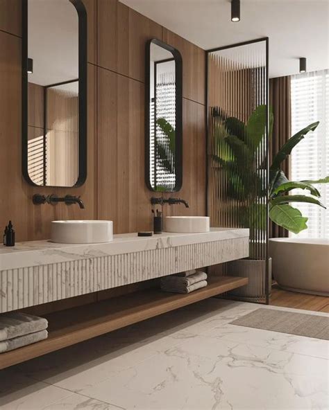 A Bathroom With Two Sinks Mirrors And A Bathtub In It S Center