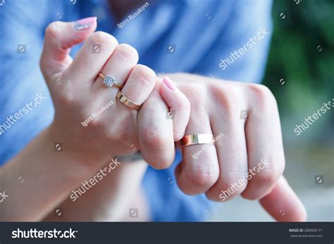 A newly weding couple place their hands on a wedding bouquet showing off their wedding rings. Married Couple Holding Hands Wedding Rings Stock Photo 288908171 - Shutterstock