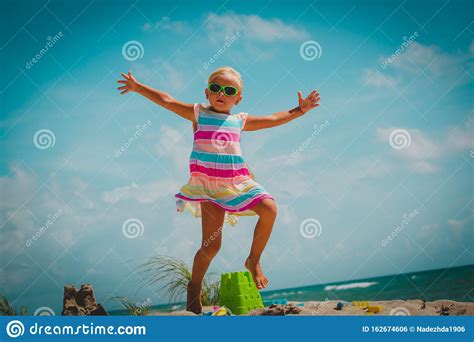 Happy Little Girl Enjoy Play With Toys On Beach Stock Photo - Image of playful, enjoy: 162674606