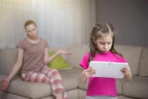 Mother Frustrating That Her Daughter Playing Video Games Stock Image