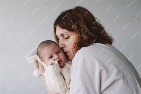 Premium Photo Portrait Of Happy Mum Holding Infant Child On Hands