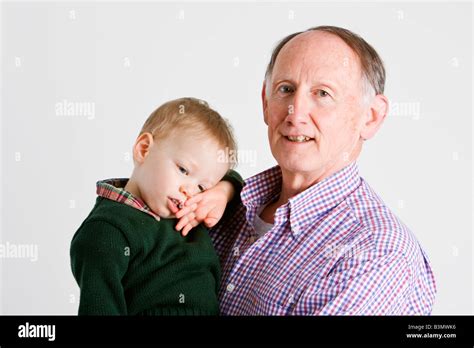 Proud Grandfather Holding His Grandson Stock Photo Alamy