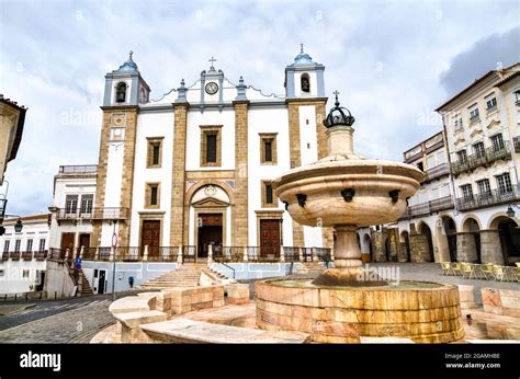 Fountain And Santo Antao Church At Giraldo Square In Evora Portugal