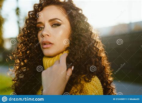 the curly brunette looked chiseled with chiseled facial features inquiringly looking into the