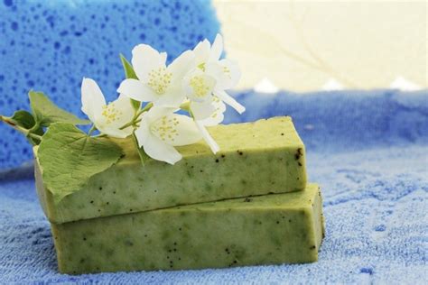 Two Bars Of Soap With Flowers On Them Sitting On A Blue Towel In The Sun