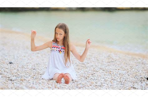 Cute Little Girl At Beach During Nature Stock Photos ~ Creative Market