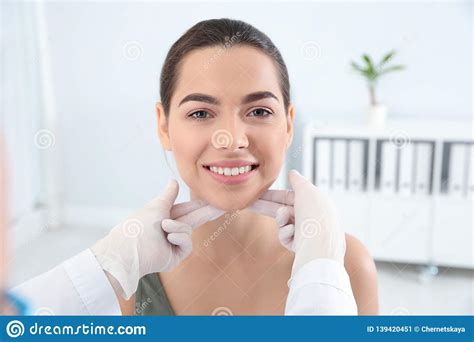 Dermatologist Examining Patient`s Face In Clinic Stock Image Image