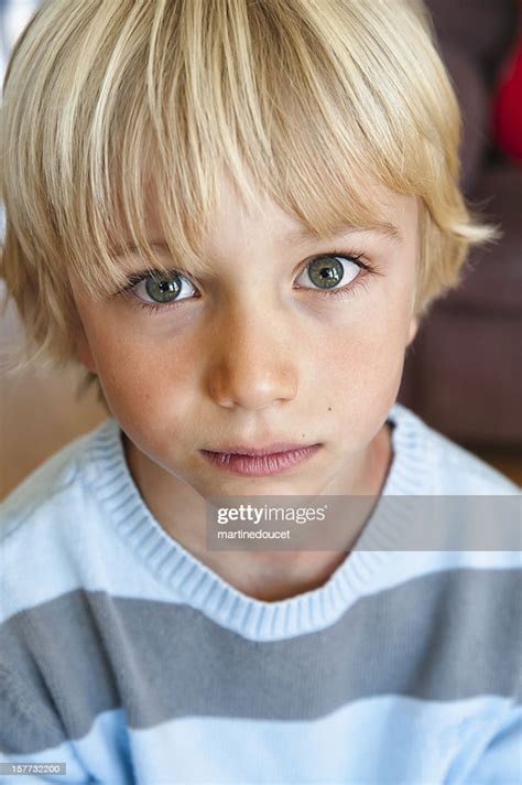 Trendy haircuts for teen boys with long hair. Portrait Of A Cute And Serious Young Boy High-Res Stock ...