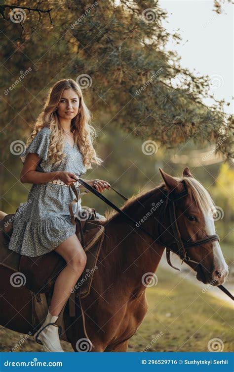 A Young Beautiful Woman Rides A Horse In The Forest In Autumn