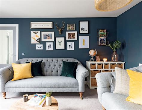 A Dark Navy Living Room With Yellow Accents And A Grey Sofa