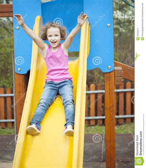 Young Girl On Slide In Playground Royalty Free Stock Photography