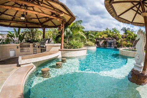Materials Tropical Beach Entry Custom Swimming Pool With A Perimeter Flow Spa Grotto Rock