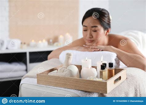 Beautiful Asian Woman Lying On Massage Table In Spa Salon