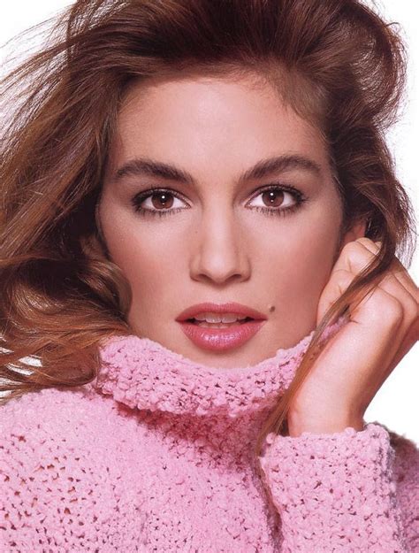 A Woman Wearing A Pink Sweater Posing For A Photo