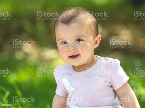 Portrait Of A Joyful Young Child Outdoors In The Park Stock Photo