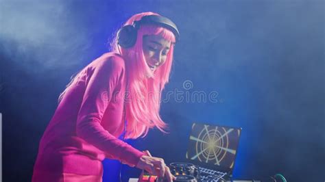 Smiling Artist Standing At Dj Table Playing Electronic Music Stock