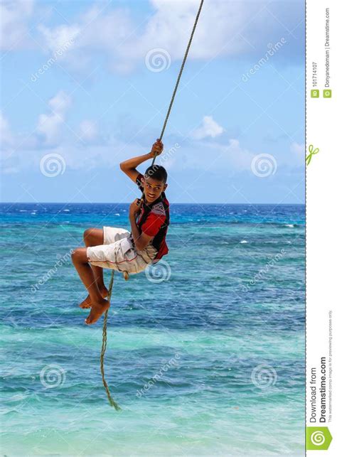 Local Boy Swinging On A Rope Swing In Lavena Village On Taveuni