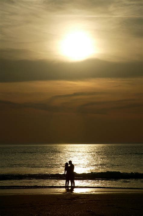 couple at sunset on beach photograph by jezphotos fine art america