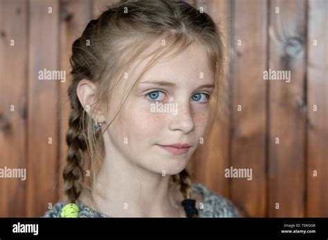 Beautiful Blond Young Girl With Freckles Indoors On Wooden Background Close Up Portrait Stock