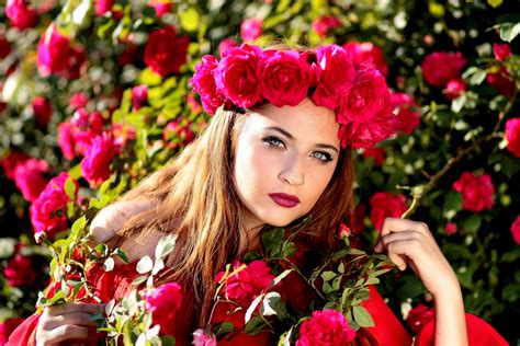 Beautiful Girl With A Wreath Of Red Roses On Her Head