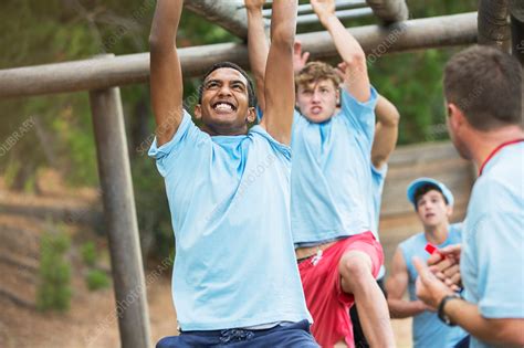 Determined Men Swinging On Monkey Bars Stock Image F Science Photo Library