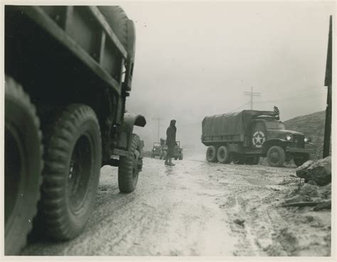 Italian Soldier Directing American Cckw Trucks At Intersection In Italy
