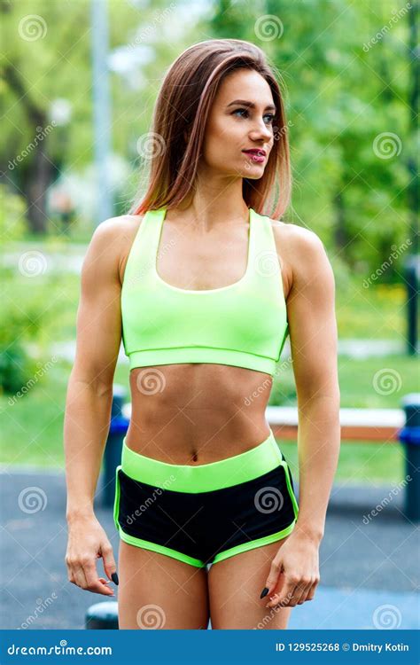 Sporty Woman With Perfect Athletic Body Posing On Sportsground Stock