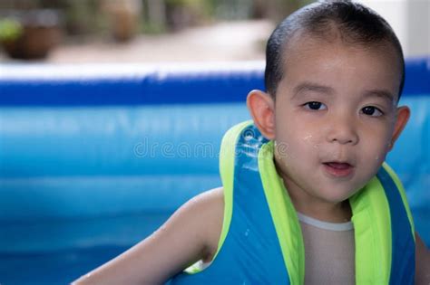 Happy Funny Baby Boy Kid Toddler Wearing Life Jacket Playing Water In