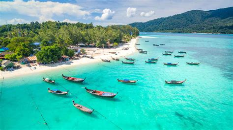 Long Teil Boats On Sunrise Beach On Koh Lipe Thailand Getting Stamped